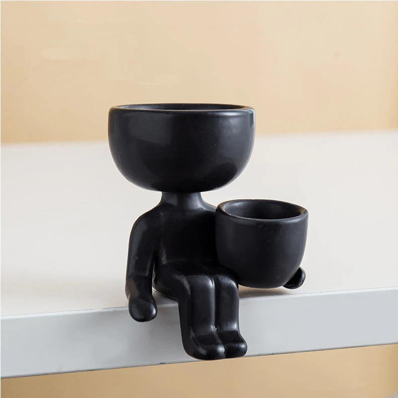 Petite Person Clay Succulent Planter Sitting Next to Pot Black